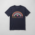 A navy blue short-sleeve t-shirt with a retro-style rainbow graphic and the text 'PINK BIRDS' printed on the chest, displayed flat against a light gray background.