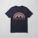A navy blue short-sleeve t-shirt with a retro-style rainbow graphic and the text 'PINK BIRDS' printed on the chest, displayed flat against a light gray background.